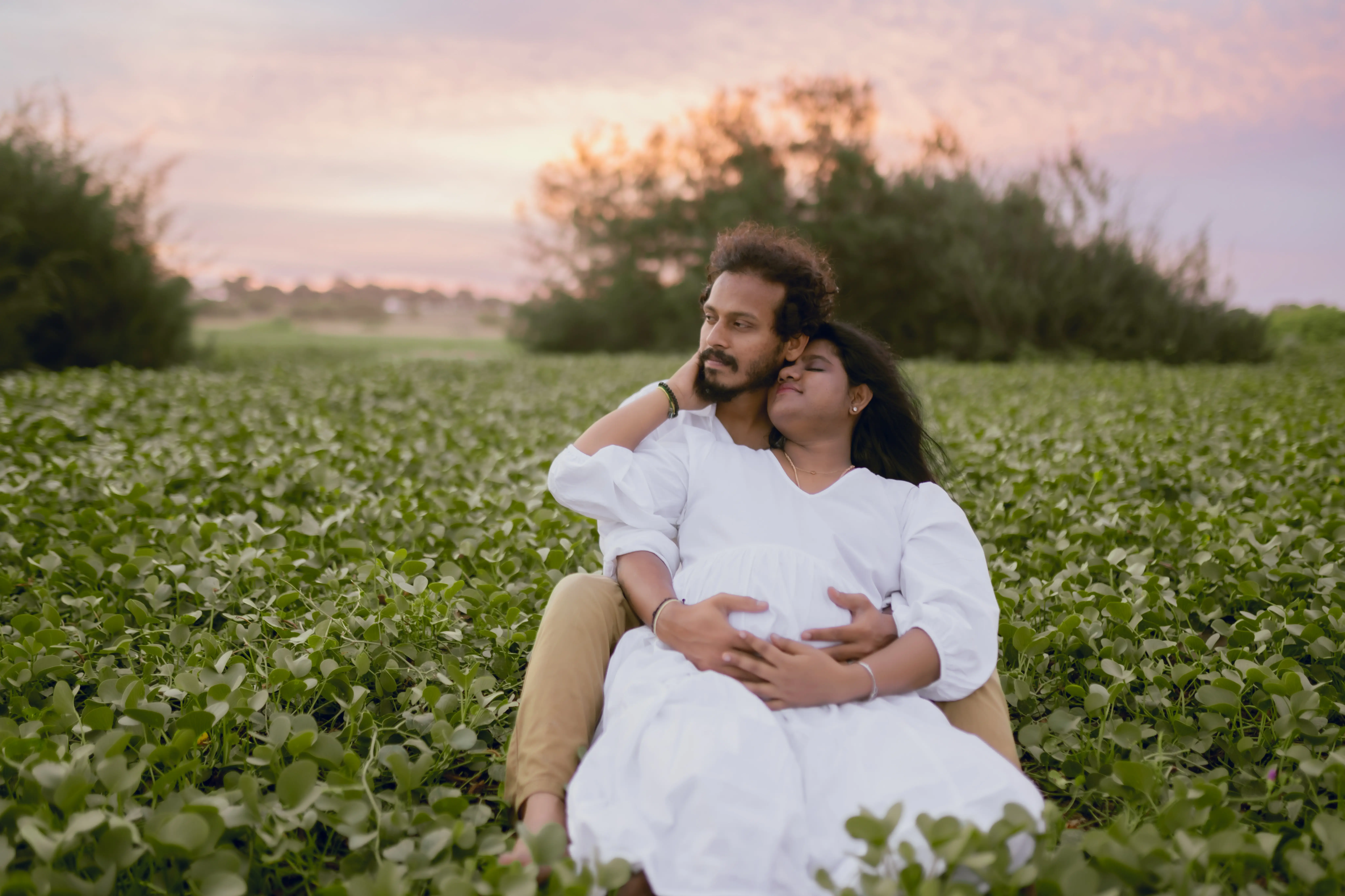 Beautiful maternity photos of an expecting mother and partner during a professional studio session.